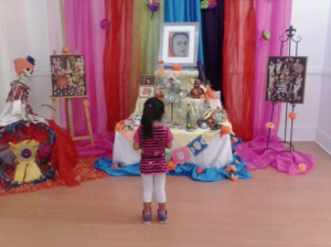 DIA DE LOS MUERTOS: A girl looks at an ofrenda  dedicated to Frieda Kahlo. PHOTO BY SANTANA JUACHE