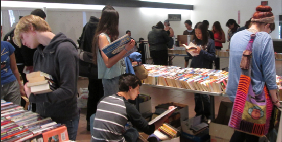 BOOKS, BOOKS EVERYWHERE : Students gather, lost in the silent search of the next book to add to arms already full. PHOTO BY ORLANDO JOSE