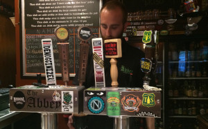 AT THE ABBEY: Bartender Josh Dick pours a glass of beer. PHOTO BY ZACARIAH MERCES-SPINDLER
