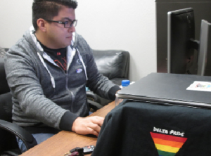 PRIDE CENTER: Delta Pride president Chris Sandoval reviews his email as he prepares for the Transgender Day of Remembrance. PHOTO BY ORLANDO JOSE