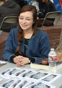 NEW ERA, NEW EDITOR: Summer Migliori runs the table for the Writers’ Guild during Club Rush on Feb. 4. PHOTO BY JERMAINE DAVIS